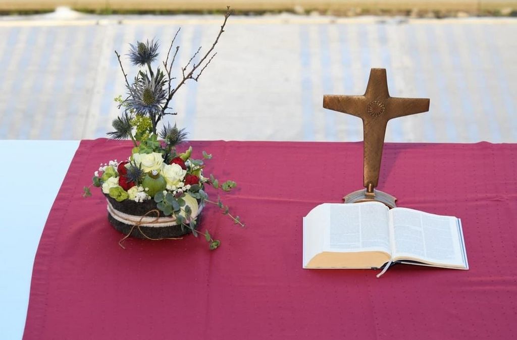 Altar mit Blumengedeck, Kreuz und Bibel beim Kirchentag in Dortmund 2019
